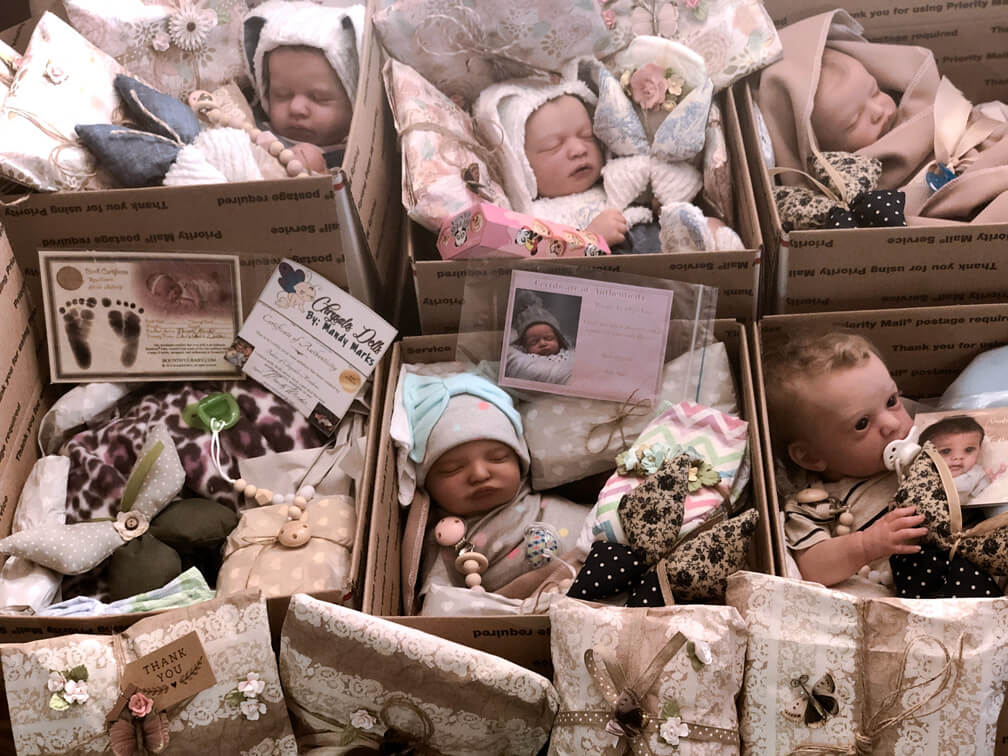 A variety of babies in their delivery boxes ready to go home.