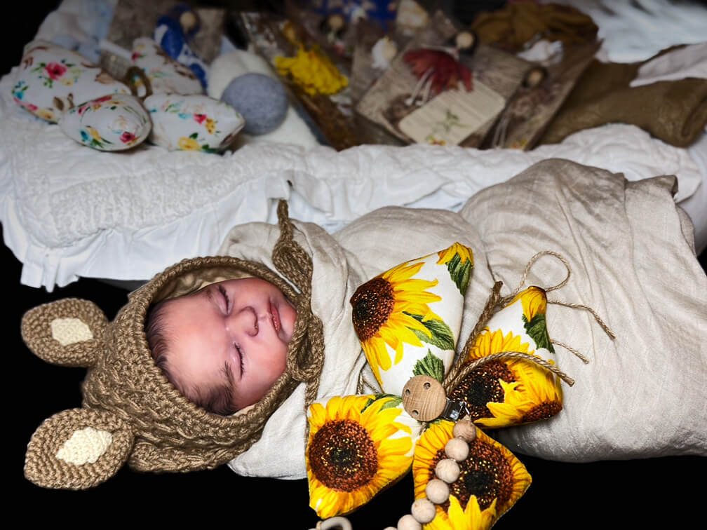 Swaddled baby surrounded by Guardian Butterflies and Barefoot Mountain Fairies.