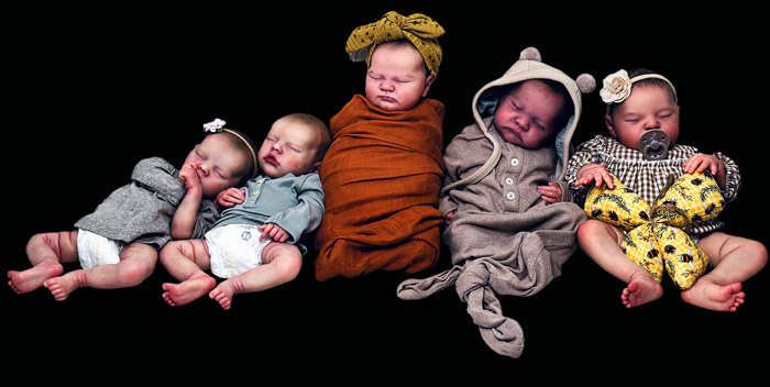 Left to Right: Twin A & B with peach skin tone, Quinlyn with a rose skin tone, Levi with a cinnamon skin tone and Laura with a olive skin tone. All five Reborns sculpted by Bonnie Brown